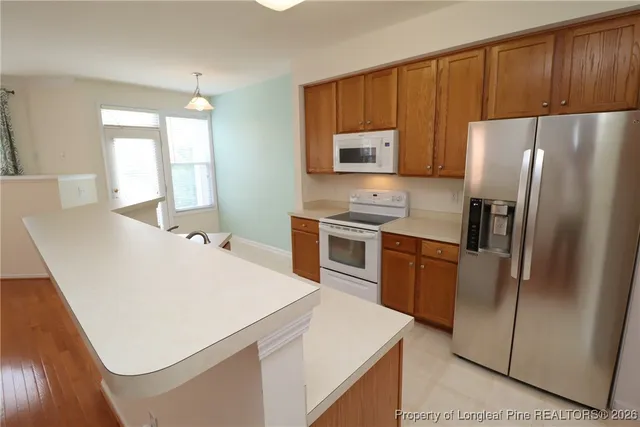 a kitchen with stainless steel appliances a stove a microwave sink and cabinets