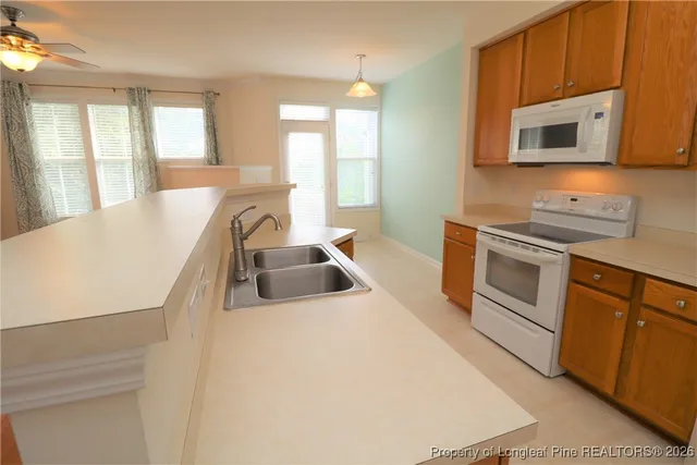 a kitchen with a sink cabinets and window