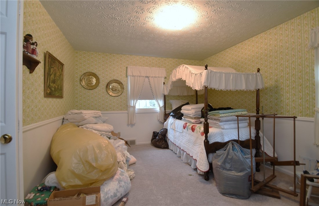 7912 Stow Road Hudson, OH 44236 - Photo 24 of 35 Bedroom featuring light carpet and a textured ceiling