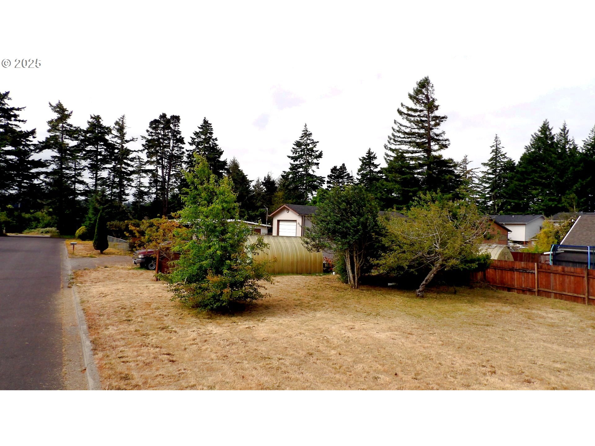 Tamarack Florence, OR 97439 - Photo 7 of 13 a backyard of a house with table and chairs
