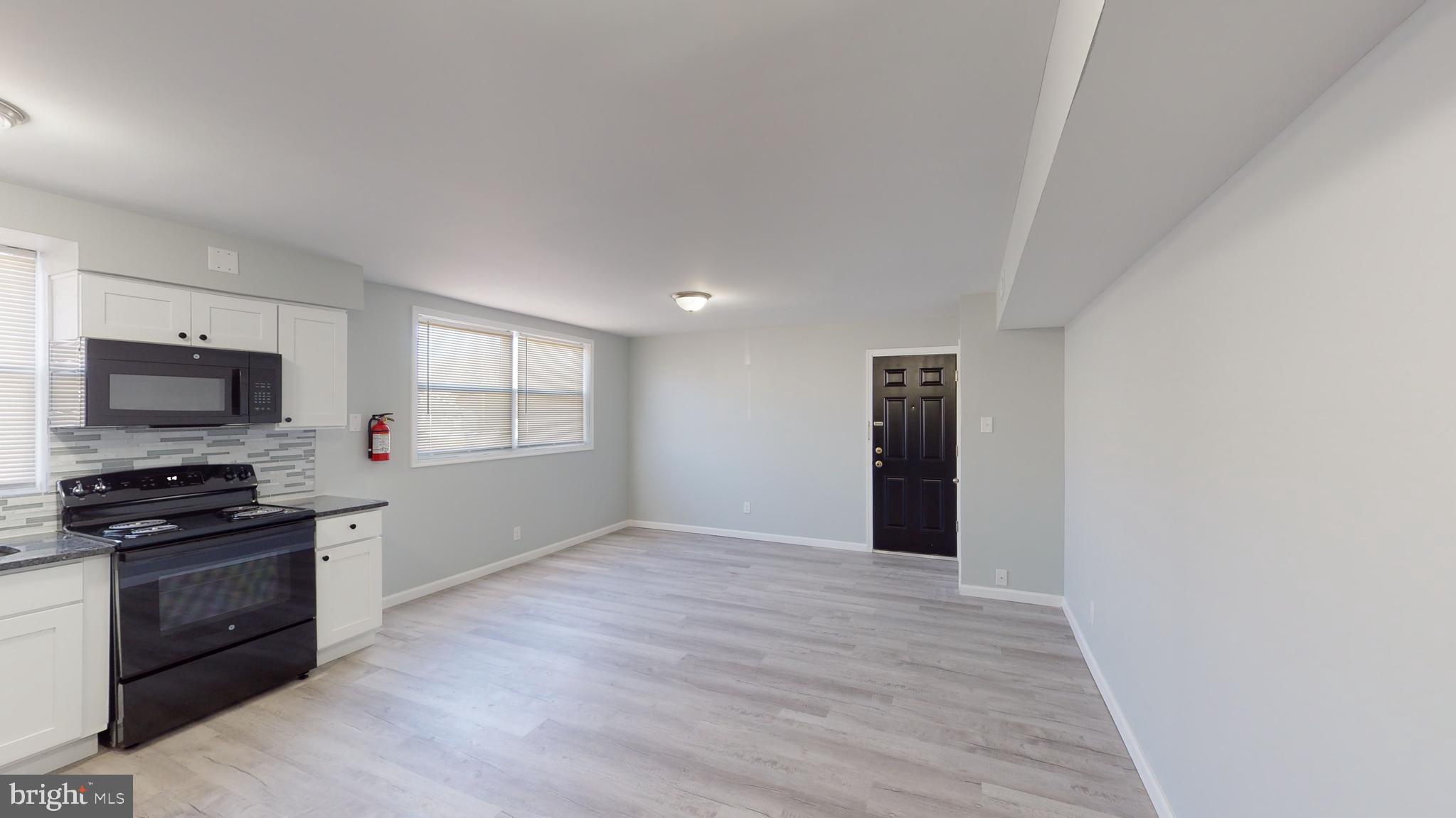 910 Gateway Boulevard, Unit A6 Westville, NJ 08093 - Photo 5 of 12 a kitchen with granite countertop a stove and a refrigerator