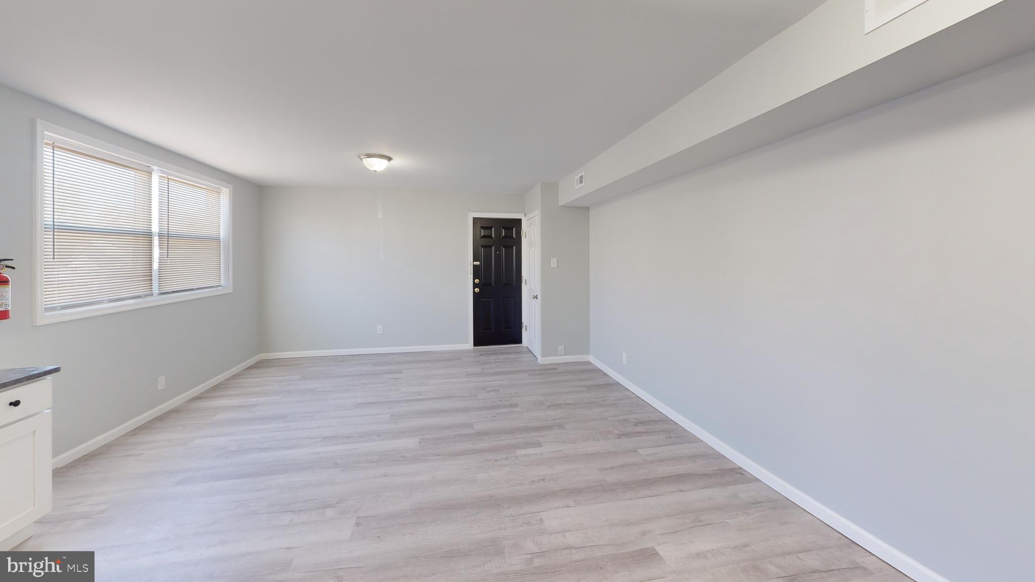 910 Gateway Boulevard, Unit A6 Westville, NJ 08093 - Photo 10 of 12 wooden floor in an empty room with a window