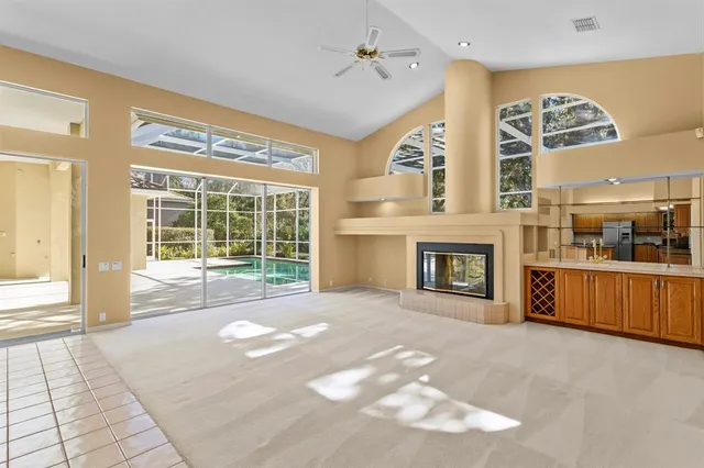 a kitchen with stainless steel appliances a sink counter space cabinets and a large window