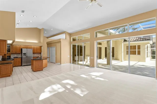 a kitchen with stainless steel appliances granite countertop a refrigerator a stove and a microwave