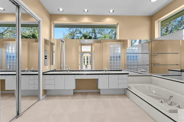 a bathroom with a sink a mirror and a shower