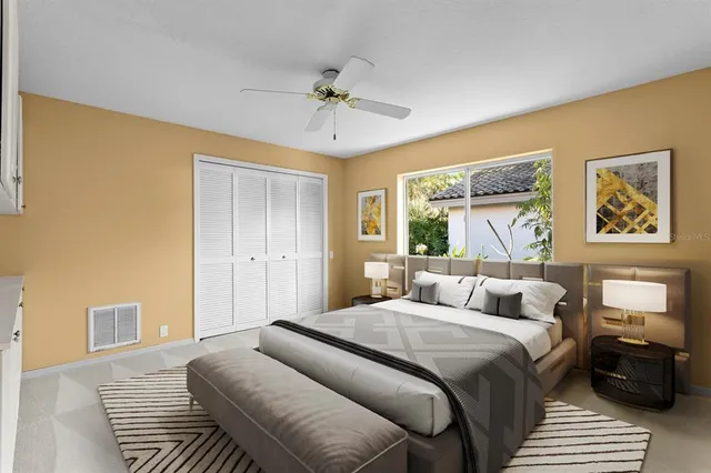 a living room with patio furniture and floor to ceiling windows