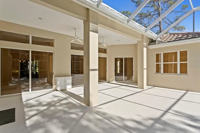 an aerial view of residential houses with outdoor space and trees