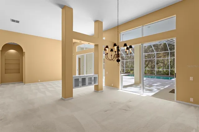 a view of an empty room with a fireplace and a window