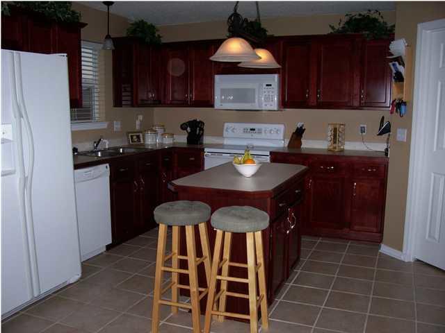 293 Limestone Circle Crestview, FL 32539 - Photo 11 of 20 a kitchen with a cabinets a sink and appliances