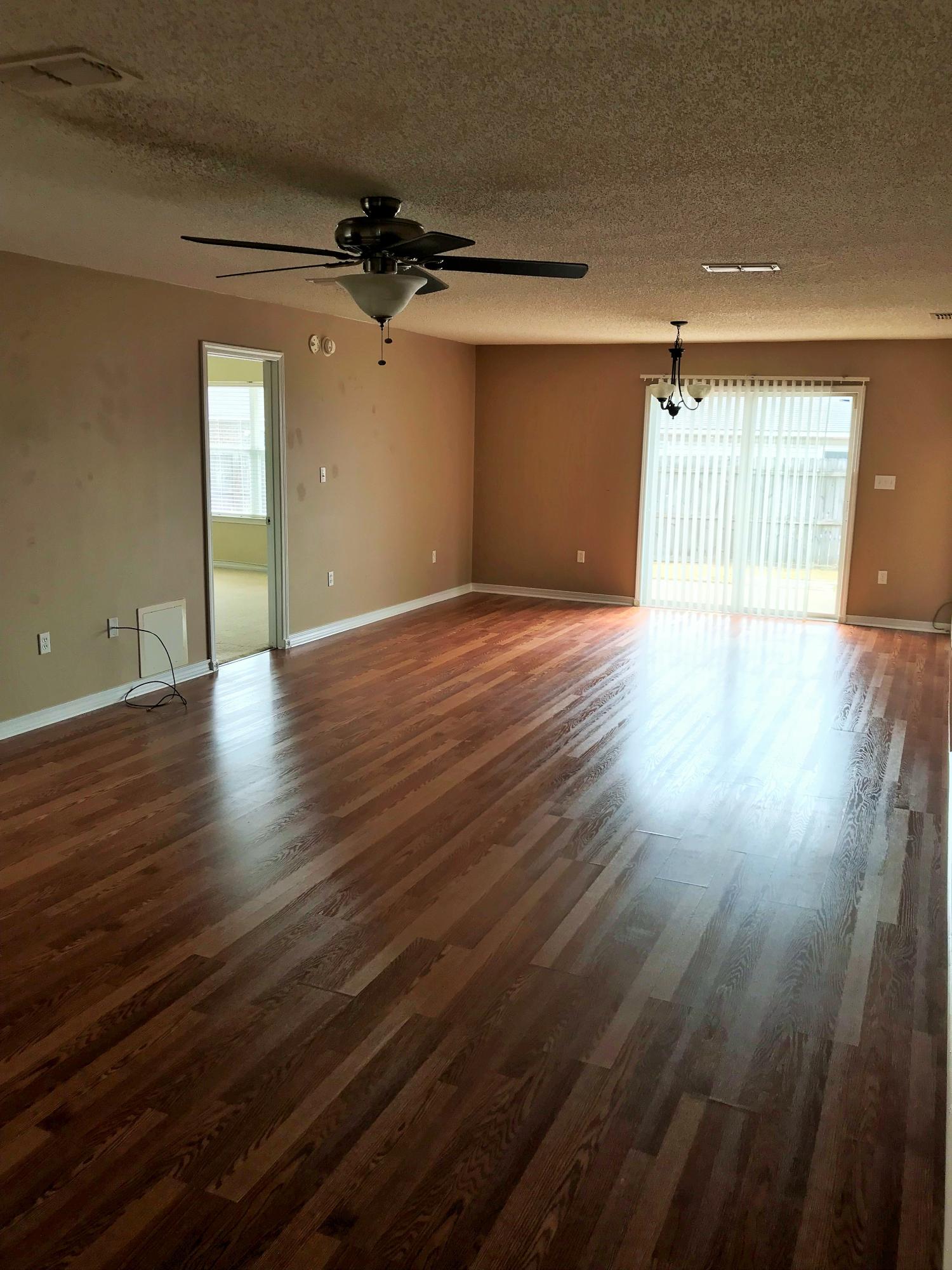 293 Limestone Circle Crestview, FL 32539 - Photo 13 of 20 an empty room with wooden floor and windows
