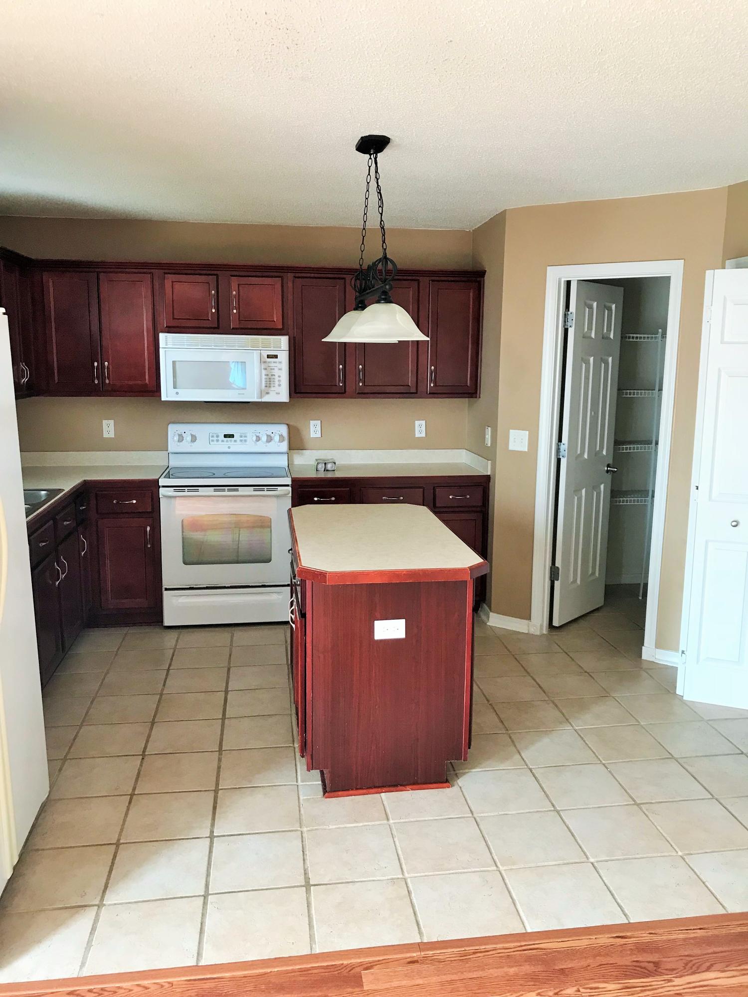 293 Limestone Circle Crestview, FL 32539 - Photo 15 of 20 a kitchen with stainless steel appliances granite countertop a stove a sink and a refrigerator