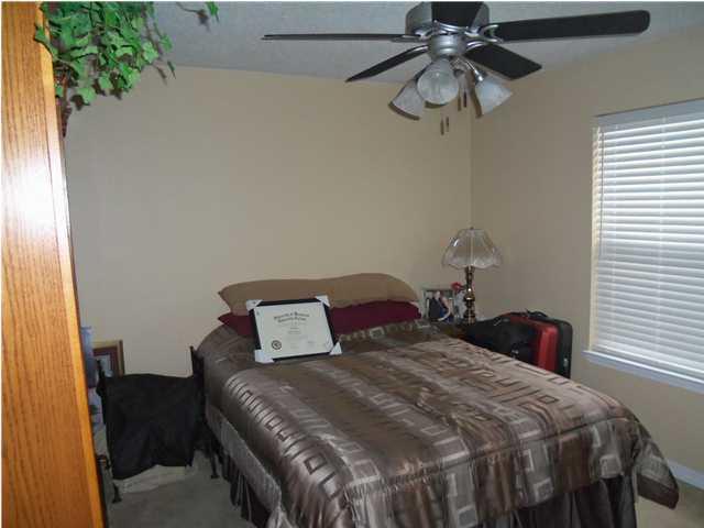 293 Limestone Circle Crestview, FL 32539 - Photo 2 of 20 a bedroom with a bed and a chandelier