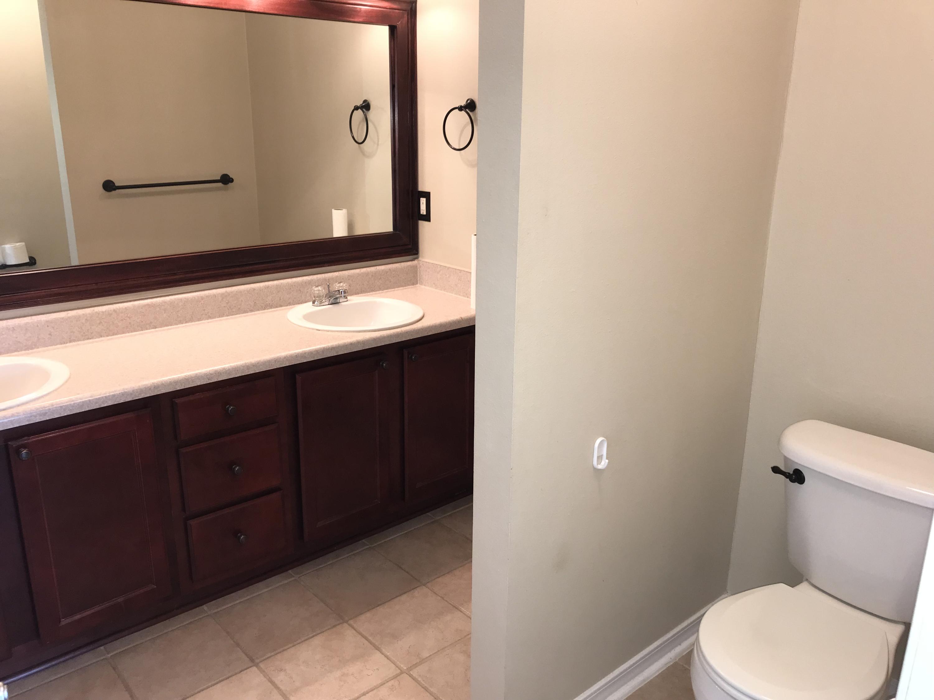 293 Limestone Circle Crestview, FL 32539 - Photo 5 of 20 a bathroom with a toilet a sink and mirror