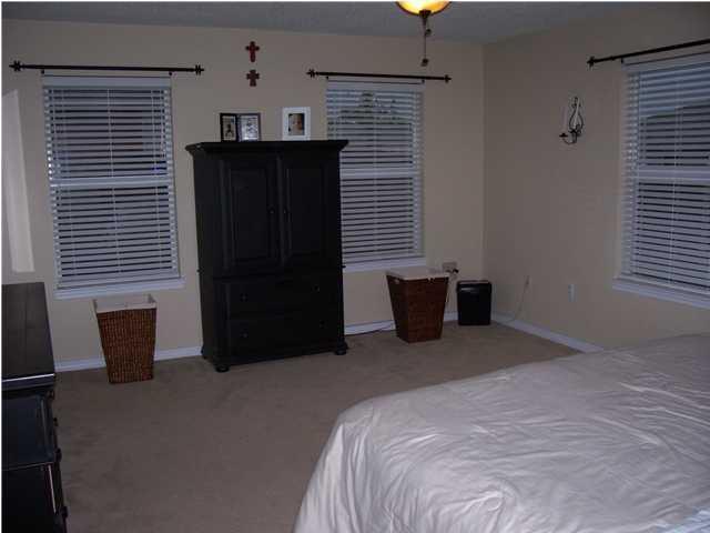 293 Limestone Circle Crestview, FL 32539 - Photo 8 of 20 a bedroom with a bed and a window
