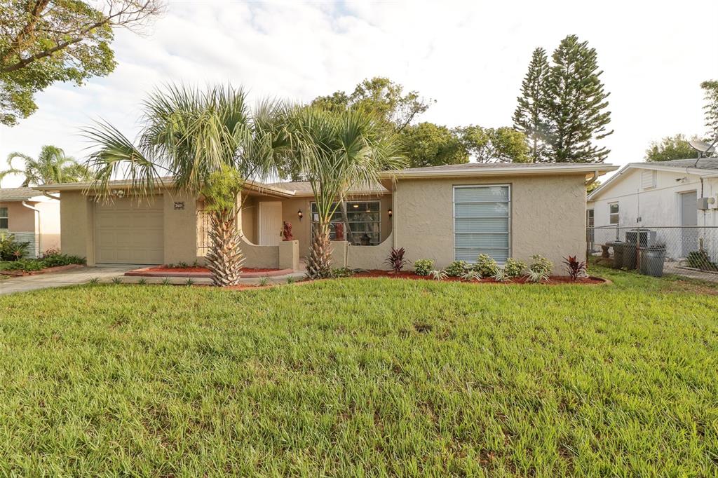 7401 Oak Crest Drive Port Richey, FL 34668 - Photo 1 of 1 a view of a house with yard and tree s