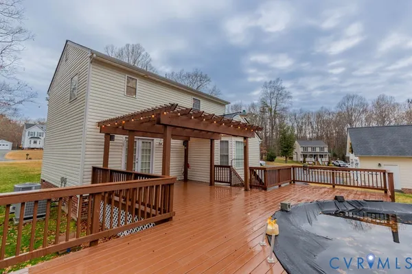 a view of a house with wooden deck and furniture