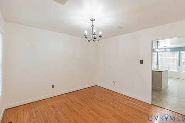 a view of a room with wooden floor and windows