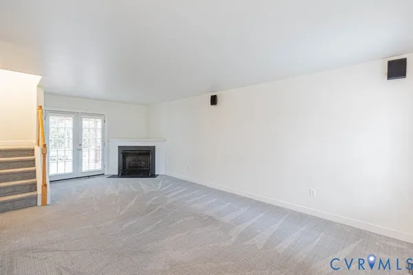 a view of an empty room with a fireplace