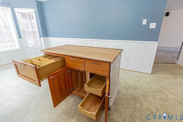 a kitchen with a refrigerator sink and cabinets