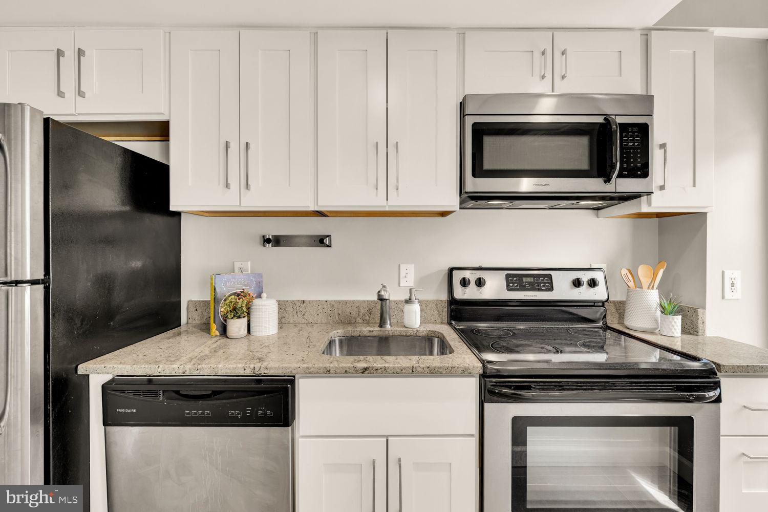 1750 Harvard Street Northwest, Unit 3C Washington, DC 20009 - Photo 11 of 29 a kitchen with stainless steel appliances granite countertop a stove microwave and refrigerator