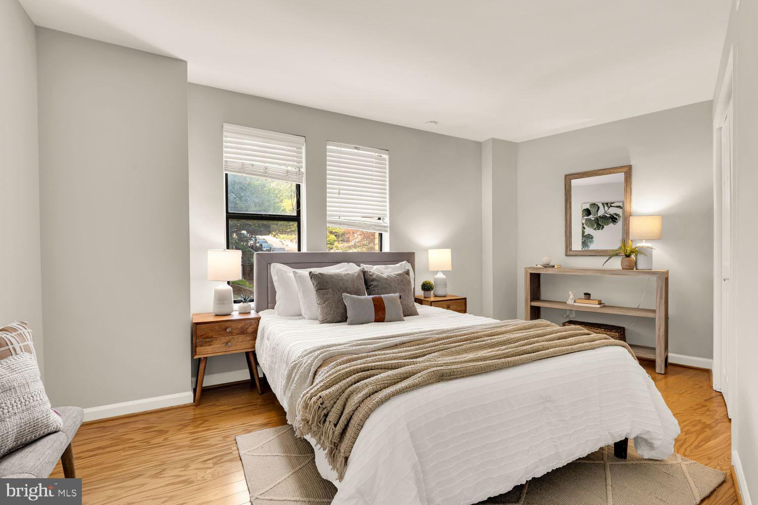 1750 Harvard Street Northwest, Unit 3C Washington, DC 20009 - Photo 15 of 29 a bedroom with a bed and wooden floor
