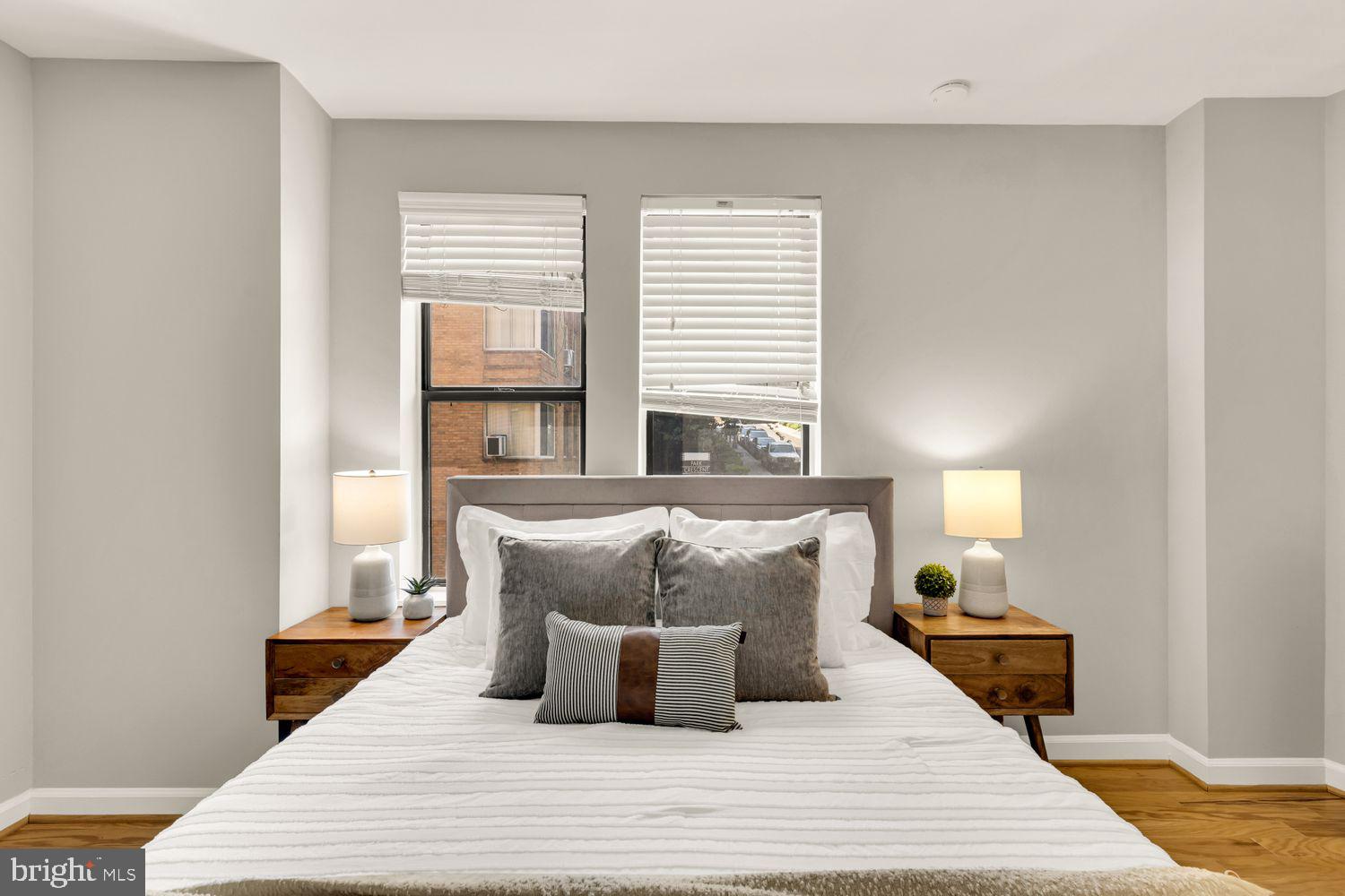 1750 Harvard Street Northwest, Unit 3C Washington, DC 20009 - Photo 16 of 29 a bedroom with a bed and wooden floor