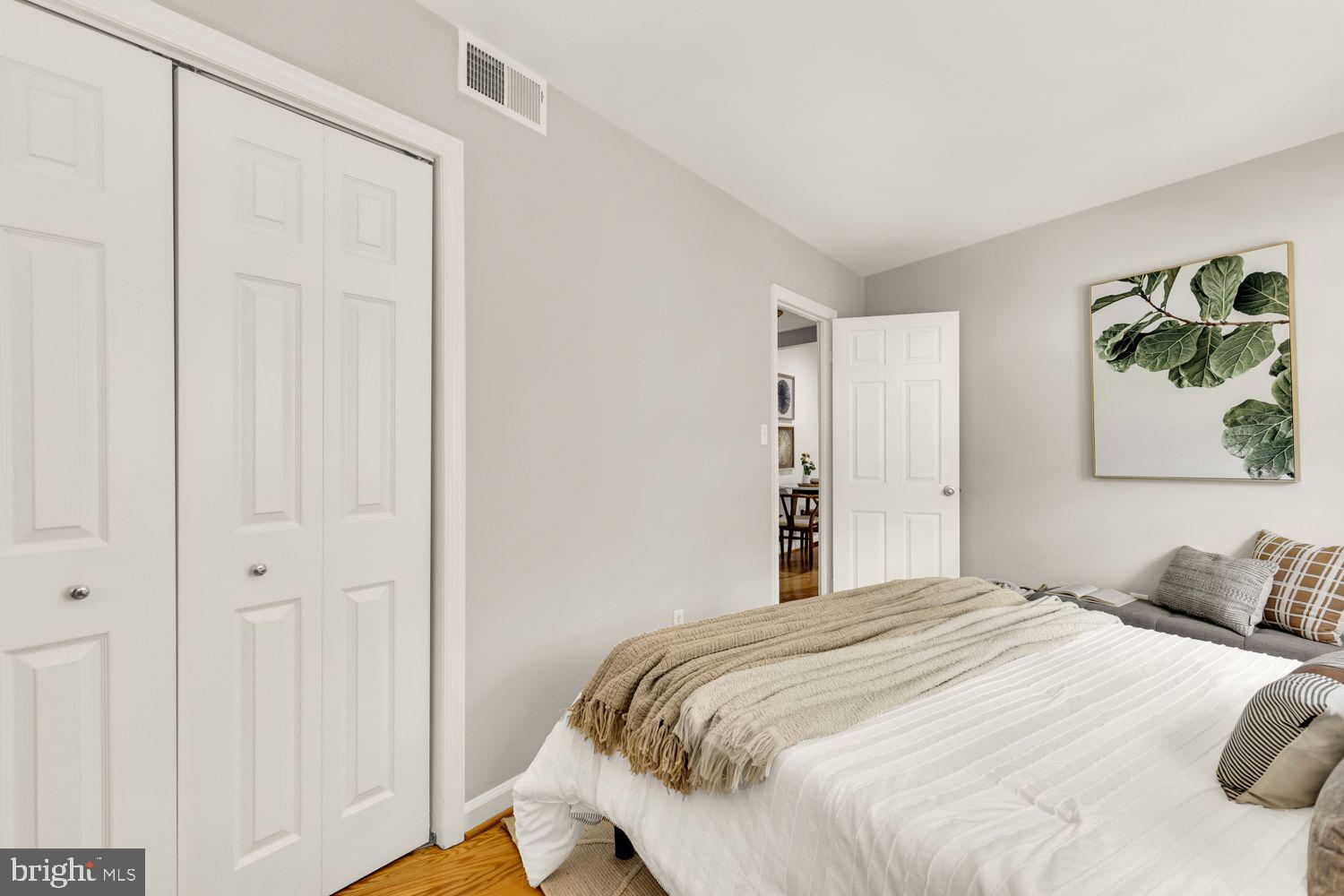 1750 Harvard Street Northwest, Unit 3C Washington, DC 20009 - Photo 17 of 29 a bedroom with a bed and a painting on the wall