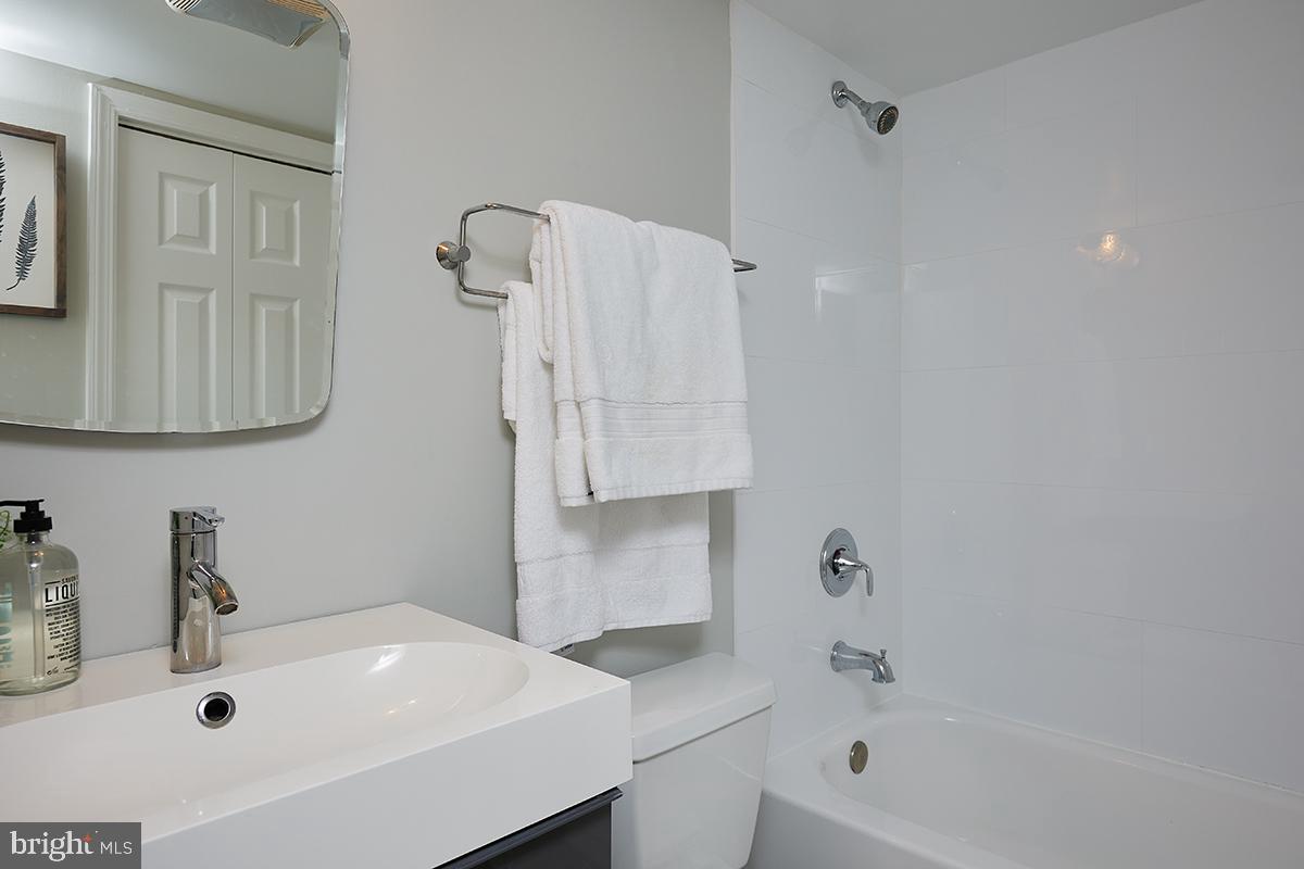 1750 Harvard Street Northwest, Unit 3C Washington, DC 20009 - Photo 19 of 29 a bathroom with a sink a toilet and shower
