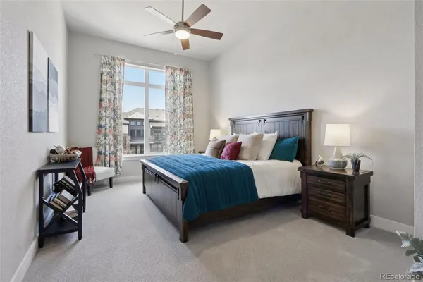 a spacious bedroom with a bed and a chandelier