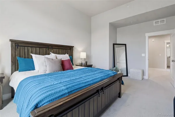 a bed sitting in a bedroom and wooden floor