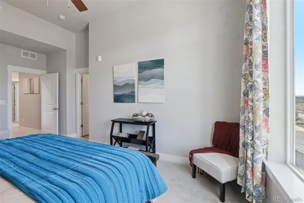 a bedroom with a bed and a couch