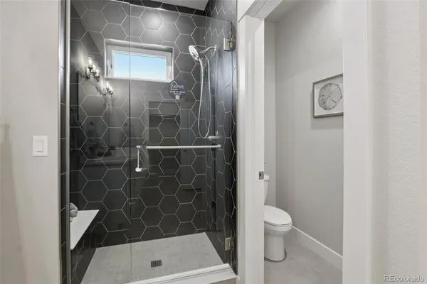 a bathroom with a toilet and a shower