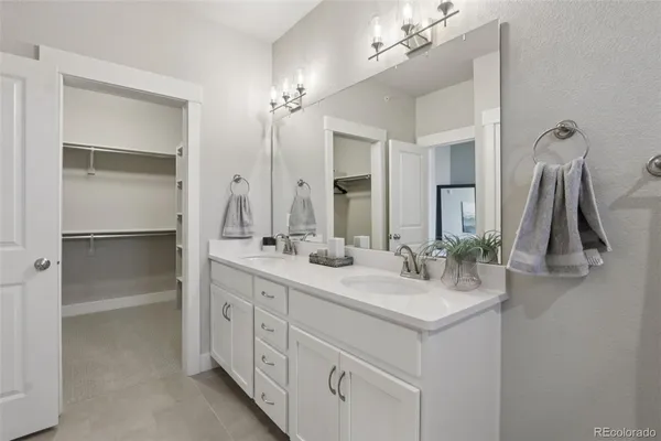 a bathroom with a double vanity sink a vanity and a mirror