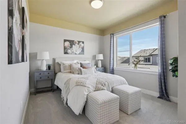 a bedroom with a bed and a large mirror