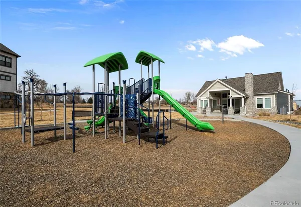 a room with lots of tables a large window and chairs