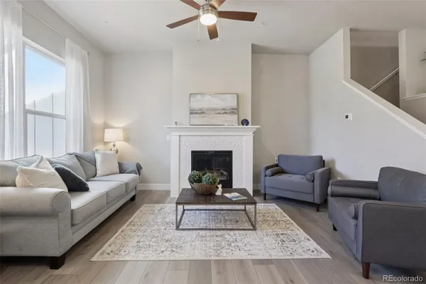 a living room with furniture and a fireplace