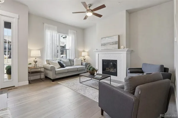 a living room with furniture and a fireplace
