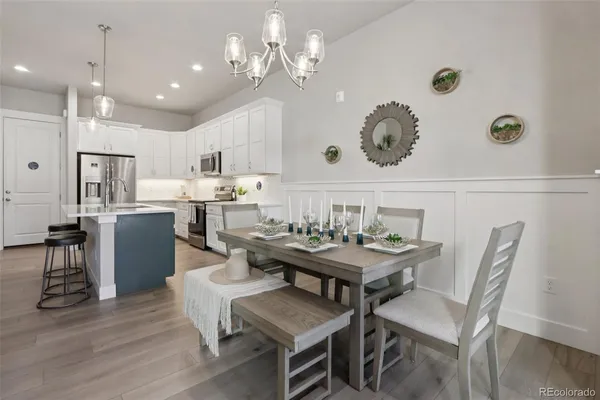 a view of a dining room with furniture and chandelier