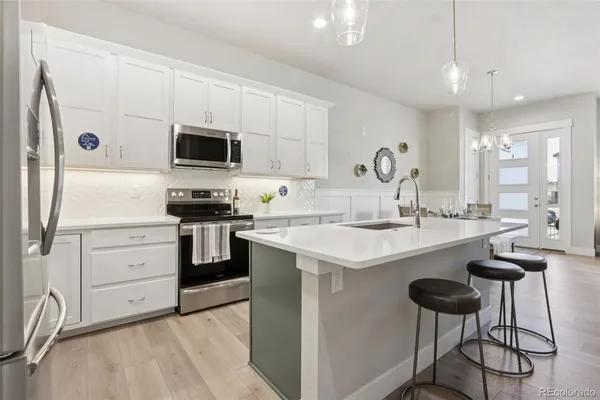 a kitchen with a sink cabinets and stainless steel appliances