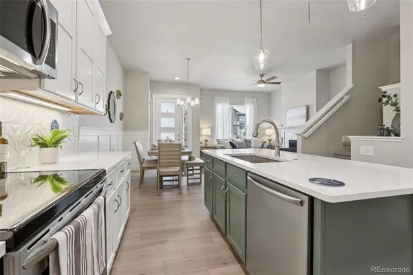 a kitchen with sink stove and cabinets