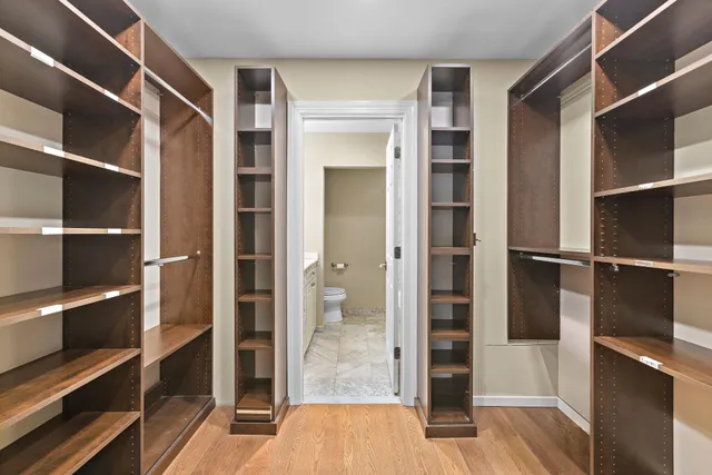 a view of walk in closet with empty racks