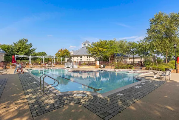 a view of swimming pool with outdoor seating and plants