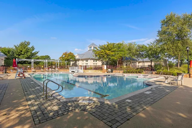 a view of swimming pool with outdoor seating and plants