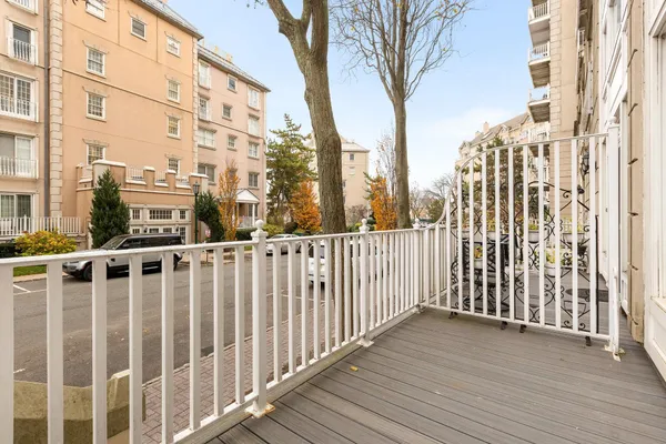 a view of a balcony with wooden fence