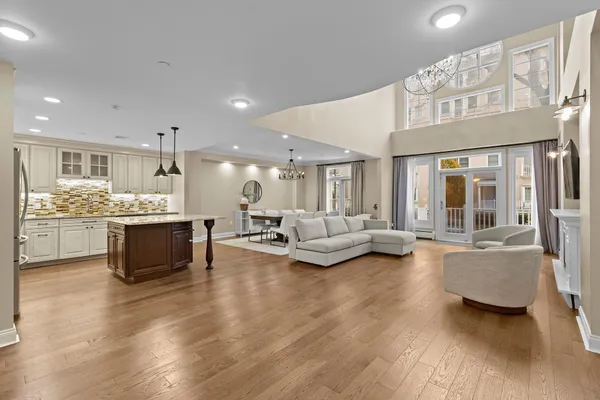a living room with furniture and kitchen view