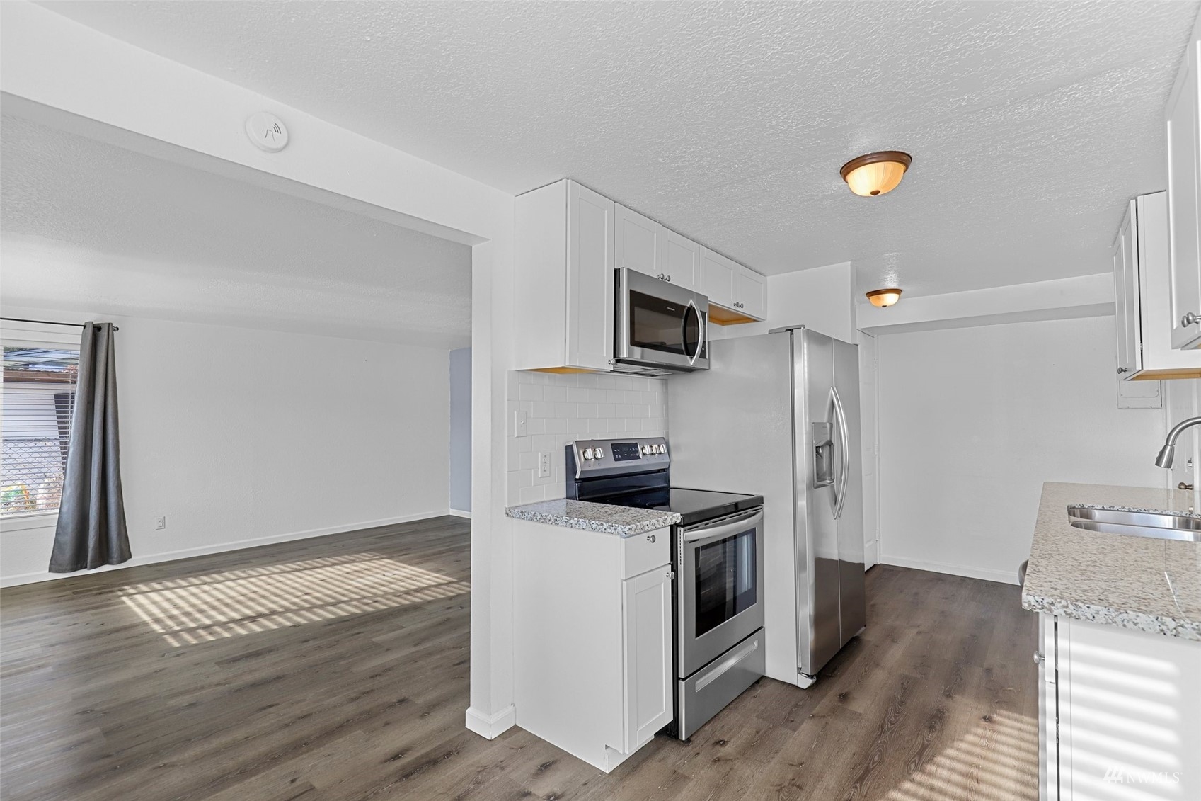 25 Rips Lane Southwest Lakewood, WA 98499 - Photo 11 of 33 a kitchen with a sink appliances and cabinets