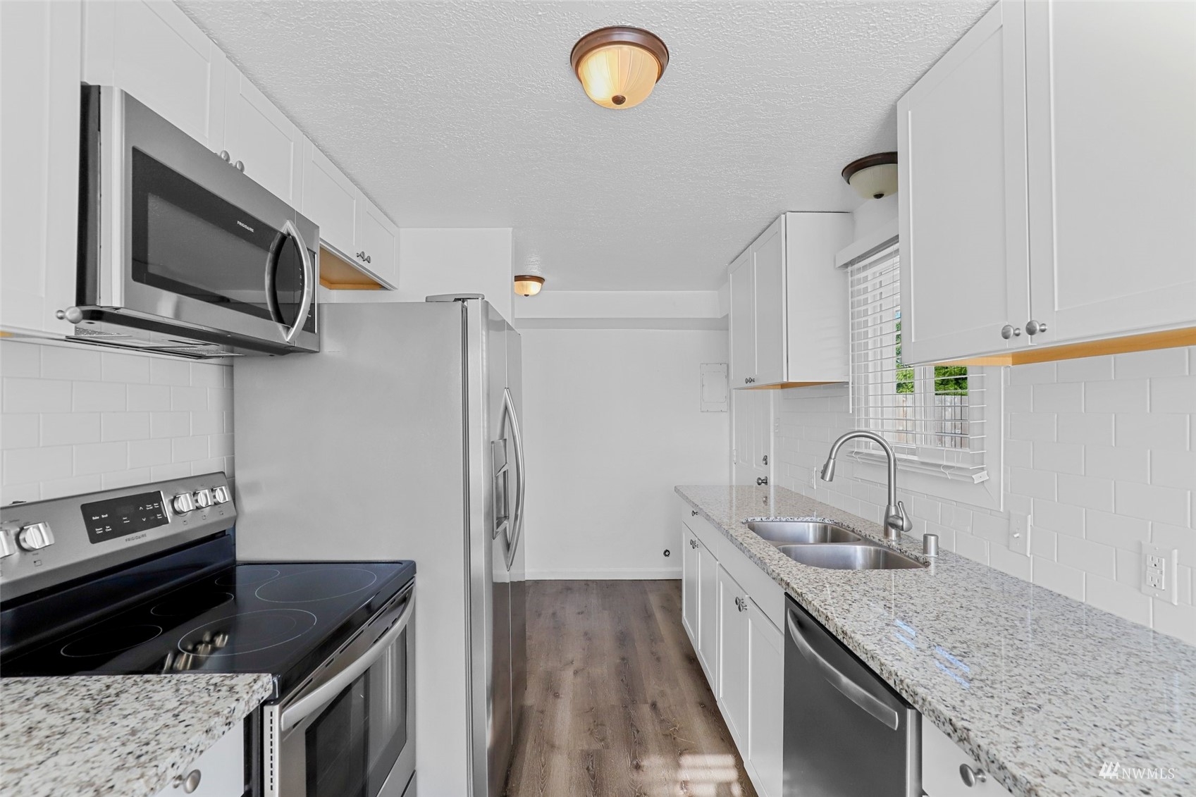25 Rips Lane Southwest Lakewood, WA 98499 - Photo 12 of 33 a kitchen with stainless steel appliances granite countertop a sink stove and microwave