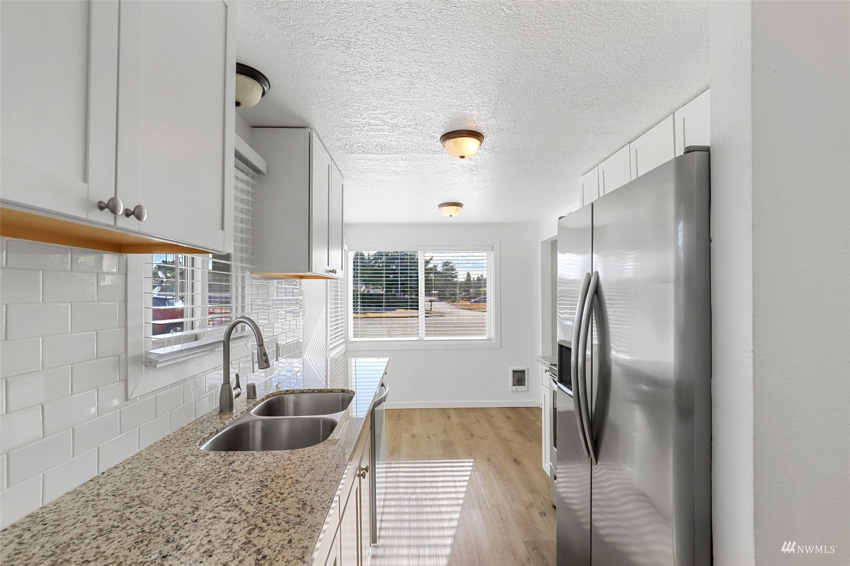 25 Rips Lane Southwest Lakewood, WA 98499 - Photo 14 of 33 a kitchen with a refrigerator and a sink