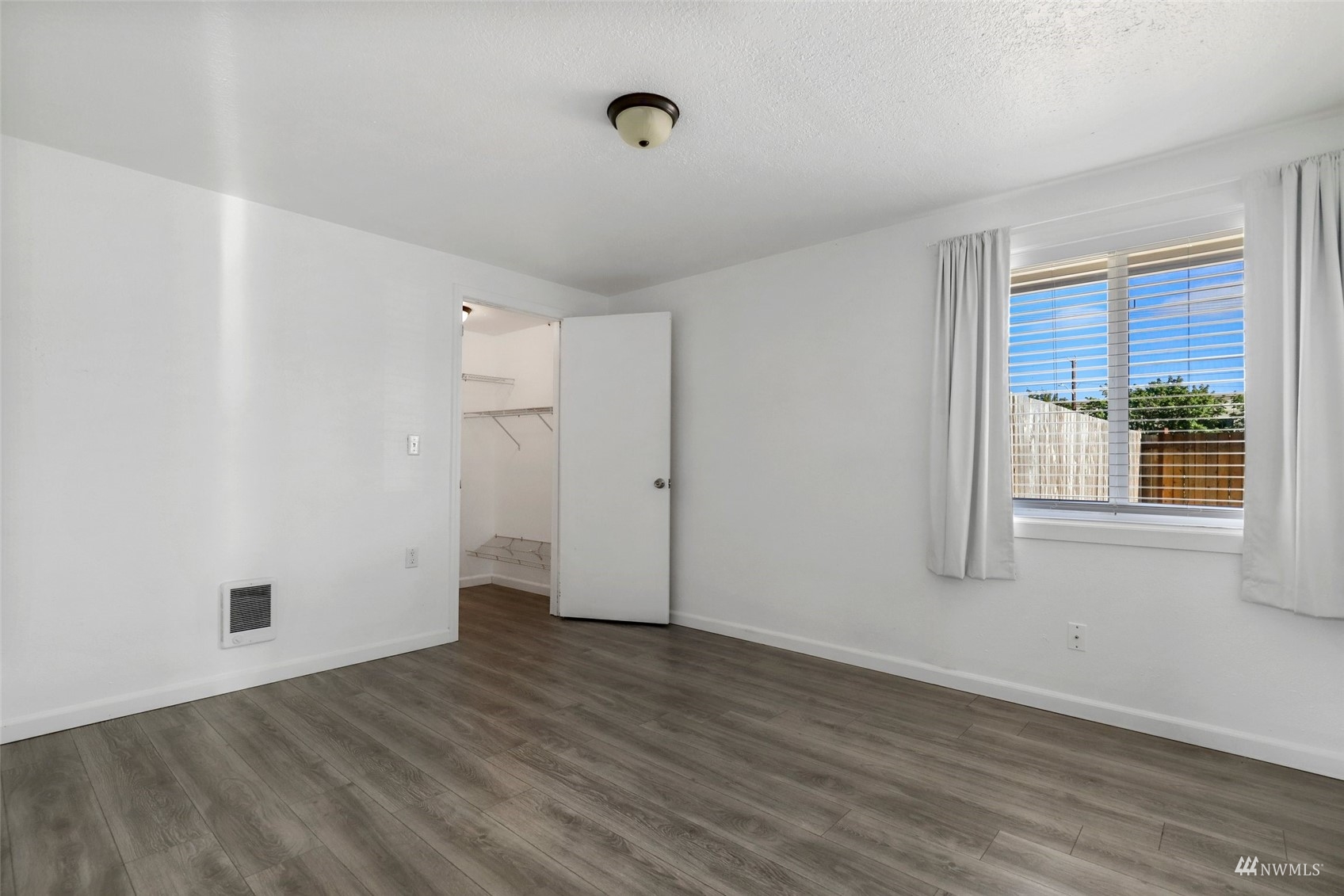25 Rips Lane Southwest Lakewood, WA 98499 - Photo 17 of 33 a view of an empty room with wooden floor and a window
