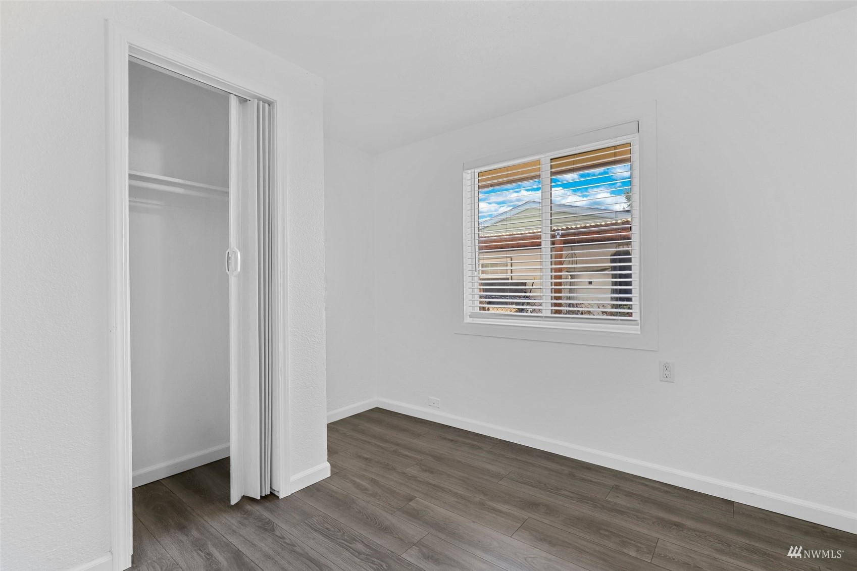 25 Rips Lane Southwest Lakewood, WA 98499 - Photo 21 of 33 a view of an empty room with wooden floor and a window